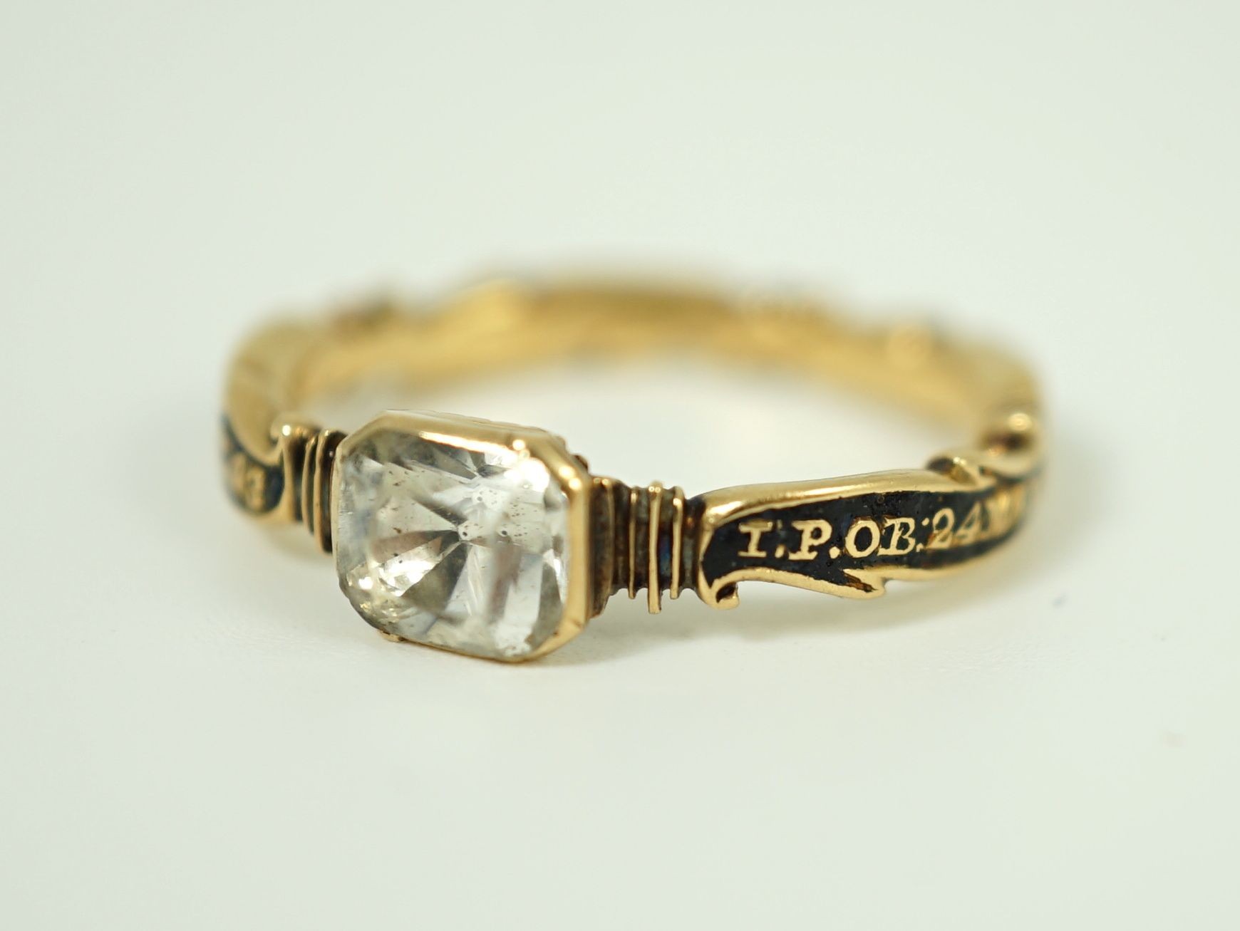 A George II gold, black enamel and rock crystal set mourning ring